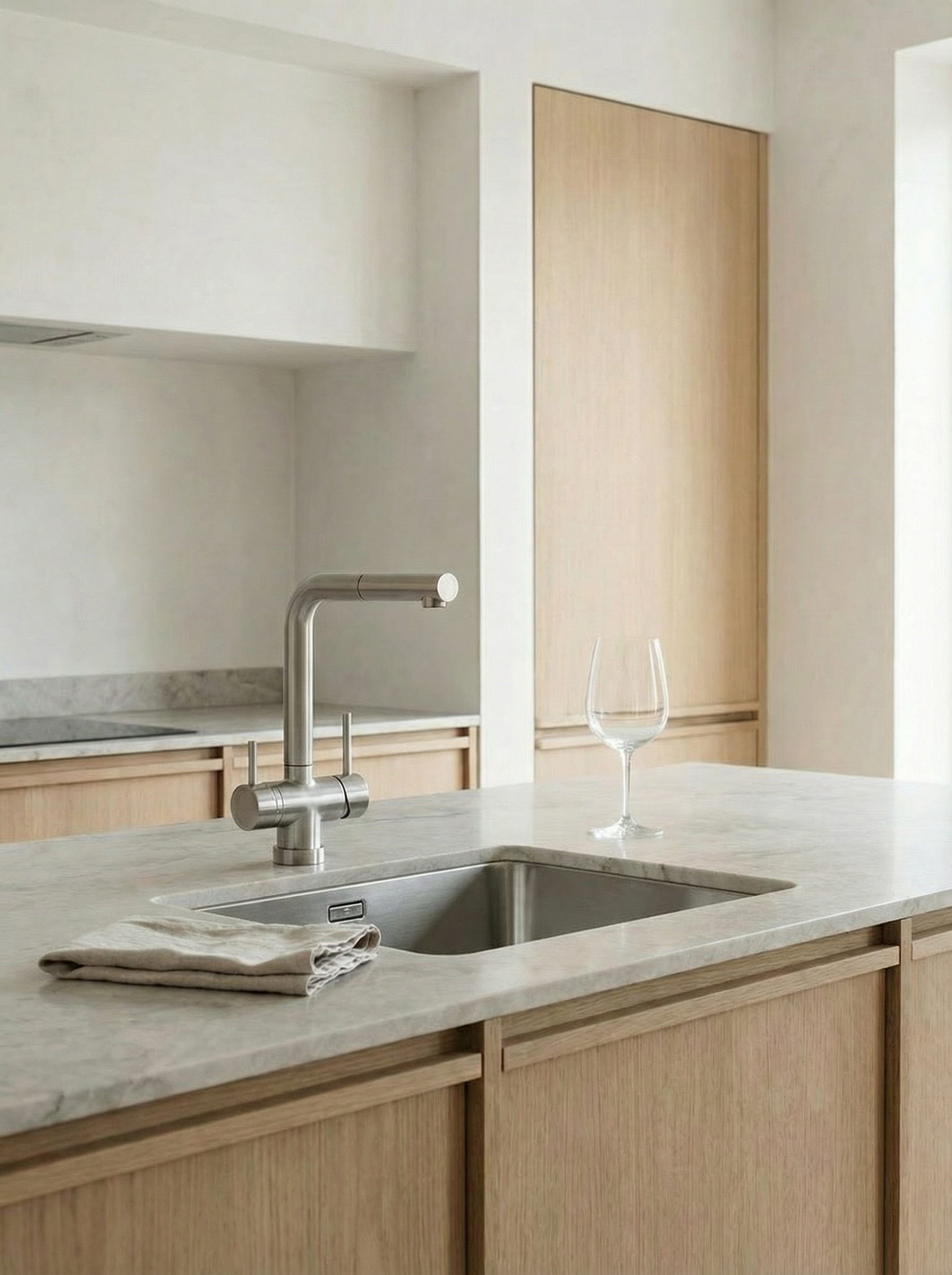 Modern kitchen mixer tap in stainless steel in a minimalist kitchen